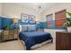 Stylish bedroom featuring a blue accent wall, modern lighting, and coordinated decor at 11878 N Hershey St, Surprise, AZ 85388