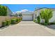 A beautiful one-story home featuring a stone driveway, lovely landscaping, and a welcoming two-car garage at 11878 N Hershey St, Surprise, AZ 85388