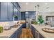 Contemporary kitchen boasting blue cabinetry, stainless steel appliances, and a center island with a sink at 11878 N Hershey St, Surprise, AZ 85388