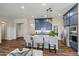 Well-lit kitchen featuring a center island with seating, complemented by blue cabinetry and modern appliances at 11878 N Hershey St, Surprise, AZ 85388