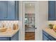 Kitchen boasts blue cabinets, light countertops, and a glass door to the pantry with wood flooring at 11878 N Hershey St, Surprise, AZ 85388