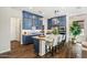 Modern kitchen with stylish blue cabinets, a large island with seating, and stainless steel appliances at 11878 N Hershey St, Surprise, AZ 85388