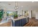 Open-concept kitchen with island seating, offering a seamless view into the stylish living and dining areas at 11878 N Hershey St, Surprise, AZ 85388