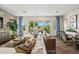 Elegant living room featuring a cozy sofa, stylish decor, and a large window with a beautiful view at 11878 N Hershey St, Surprise, AZ 85388