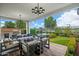 Relaxing outdoor patio featuring comfortable seating, an outdoor kitchen, and a landscaped yard at 11878 N Hershey St, Surprise, AZ 85388