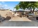 Outdoor kitchen with built-in grill, tiered planters, and patio seating, perfect for entertaining guests at 12001 N 53Rd Ave, Glendale, AZ 85304