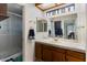 Bright bathroom with double sinks, framed mirrors, and a separate shower area at 12001 N 53Rd Ave, Glendale, AZ 85304