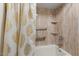 Bathroom with tub and shower featuring grab bars and built-in shelves at 12001 N 53Rd Ave, Glendale, AZ 85304