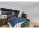 A comfortable bedroom featuring a large bed, wood furniture, and dark blinds at 12001 N 53Rd Ave, Glendale, AZ 85304