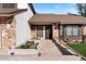 Close-up of the front of the home, showcasing a landscaped entrance, stone facade, and a welcoming front door at 12001 N 53Rd Ave, Glendale, AZ 85304