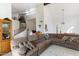 Spacious living room with soaring ceilings, a cozy sectional sofa, and a staircase leading to the second floor at 12001 N 53Rd Ave, Glendale, AZ 85304