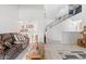 An open-concept living area features tile floors and staircase with black handrails at 12001 N 53Rd Ave, Glendale, AZ 85304