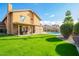 Lush backyard with green lawn, a pool view, and outdoor seating, perfect for relaxing and enjoying the scenery at 1401 E Brentrup Dr, Tempe, AZ 85283