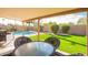 Outdoor dining area with a view of the pool and well-maintained landscaping, perfect for entertaining at 1401 E Brentrup Dr, Tempe, AZ 85283