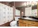 Classic bathroom with a single vanity and a shower featuring a patterned curtain, offering a traditional design at 1401 E Brentrup Dr, Tempe, AZ 85283