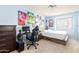 Bright bedroom with blue walls, a cozy bed, and a dedicated workspace featuring a desk and comfortable chair at 1401 E Brentrup Dr, Tempe, AZ 85283