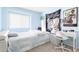 Serene bedroom with a daybed, desk, and soft blue walls, perfect for a quiet and comfortable space at 1401 E Brentrup Dr, Tempe, AZ 85283