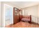 Cozy Bedroom space with wooden floors, built-in shelves, and a charming crib, creating a comforting environment at 1401 E Brentrup Dr, Tempe, AZ 85283