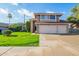 Charming two-story home with a well-manicured lawn, and an attached three car garage at 1401 E Brentrup Dr, Tempe, AZ 85283