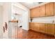 Hallway with hardwood floors and built-in cabinets leading to the bedroom at 1401 E Brentrup Dr, Tempe, AZ 85283