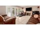 Spacious living room with a fireplace, comfortable couches, and French doors to the backyard at 1401 E Brentrup Dr, Tempe, AZ 85283