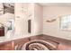 Spacious living room featuring light tile floors, hardwood floors, and a large front door at 1401 E Brentrup Dr, Tempe, AZ 85283