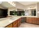Bathroom featuring dual sinks, a vanity area, and large mirrors for ample lighting at 1401 E Brentrup Dr, Tempe, AZ 85283