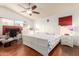 Bright and spacious main bedroom with a ceiling fan, dresser, and large window at 1401 E Brentrup Dr, Tempe, AZ 85283