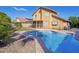 Backyard pool of tan two-story home with privacy fence and rock landscaping for low-maintenance living and outdoor fun at 1401 E Brentrup Dr, Tempe, AZ 85283