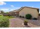 Lush backyard boasts artificial turf, desert flora, and a covered patio creating an inviting outdoor living space at 144 W Bahamas Dr, Casa Grande, AZ 85122