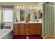 Well-lit bathroom with double vanity sinks, ample storage, and modern fixtures at 144 W Bahamas Dr, Casa Grande, AZ 85122