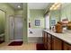Well-lit bathroom featuring double sink vanity, soaking tub and glass shower at 144 W Bahamas Dr, Casa Grande, AZ 85122