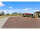 Community clubhouse with covered seating and adjacent grassy area for leisure at 144 W Bahamas Dr, Casa Grande, AZ 85122