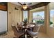 Cozy dining area featuring a ceiling fan and large windows that provide plenty of natural light at 144 W Bahamas Dr, Casa Grande, AZ 85122