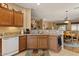 Spacious kitchen area with granite countertops, wooden cabinets, and convenient access to the dining area at 144 W Bahamas Dr, Casa Grande, AZ 85122