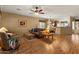 Spacious living room with wood floors, comfortable seating, and a view of the kitchen at 144 W Bahamas Dr, Casa Grande, AZ 85122