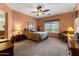 Serene main bedroom with soft carpet, a ceiling fan, and a relaxing ambiance at 144 W Bahamas Dr, Casa Grande, AZ 85122