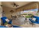 Covered patio featuring tiled flooring, modern seating, and decorative desert landscaping for relaxed outdoor living at 144 W Bahamas Dr, Casa Grande, AZ 85122