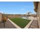 Lush backyard with a sparkling pool, desert plants, and a comfortable seating area at 14939 S 185Th Ave, Goodyear, AZ 85338