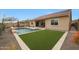 Beautiful backyard featuring a sparkling pool, artificial grass, and desert landscaping at 14939 S 185Th Ave, Goodyear, AZ 85338
