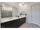 Bright bathroom boasts double sinks, sleek dark cabinetry, and a spacious tile shower at 14939 S 185Th Ave, Goodyear, AZ 85338