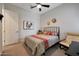 Bedroom features a ceiling fan, a comfortable rocking chair, and patterned bedding at 14939 S 185Th Ave, Goodyear, AZ 85338