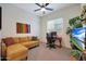 Bedroom with ceiling fan, comfortable sofa, desk area, and natural light at 14939 S 185Th Ave, Goodyear, AZ 85338