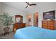 Comfortable bedroom with wood furniture, a ceiling fan, and ample closet space at 14939 S 185Th Ave, Goodyear, AZ 85338