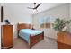 Cozy bedroom with wood furniture, a ceiling fan, and ample natural light at 14939 S 185Th Ave, Goodyear, AZ 85338