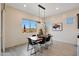 Bright dining room features a modern table setting and large windows, creating an inviting space for meals and gatherings at 14939 S 185Th Ave, Goodyear, AZ 85338