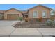 Charming exterior view of home with well-maintained desert landscaping, stone accents, and a two-car garage at 14939 S 185Th Ave, Goodyear, AZ 85338