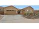 Lovely home featuring a three-car garage, mature desert landscaping and stone accents at 14939 S 185Th Ave, Goodyear, AZ 85338