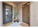 Inviting front entrance featuring a security door, potted plants, and views into the interior at 14939 S 185Th Ave, Goodyear, AZ 85338
