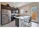 Modern kitchen featuring stainless steel appliances, sleek countertops, and a breakfast bar at 14939 S 185Th Ave, Goodyear, AZ 85338